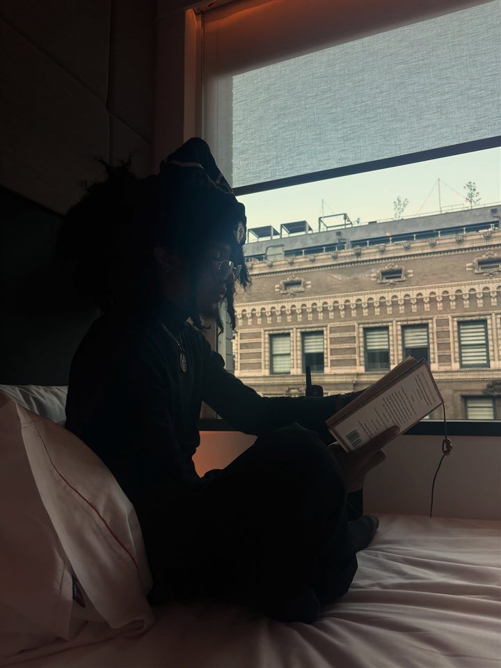 6xrpse reading by a hotel window, August 2025